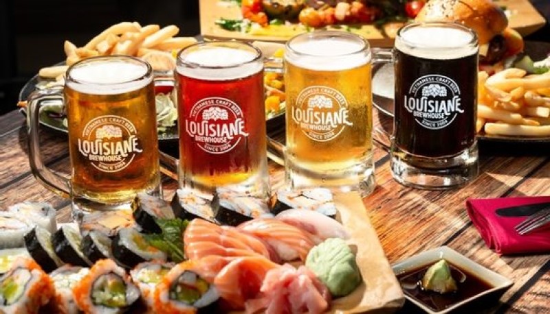 4 cups of different types of craft beer served with a plate of sushi and fries at Louisiane Nha Trang